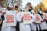 Protestors stand outside Parliament as British lawmakers debate an assisted dying law in London on Nov. 29, 2024. (OSV News photo/Mina Kim, Reuters)
