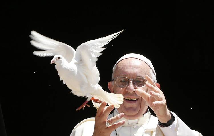 Pope Francis releases a dove outside the Basilica of St. Nicholas after meeting with the leaders of Christian churches in Bari, Italy, July 7. The pope met Christian leaders for an ecumenical day of prayer for peace in the Middle East. Pope Francis, formerly Argentine Cardinal Jorge Mario Bergoglio, died April 21, 2025, at age 88. (CNS photo/Paul Haring)